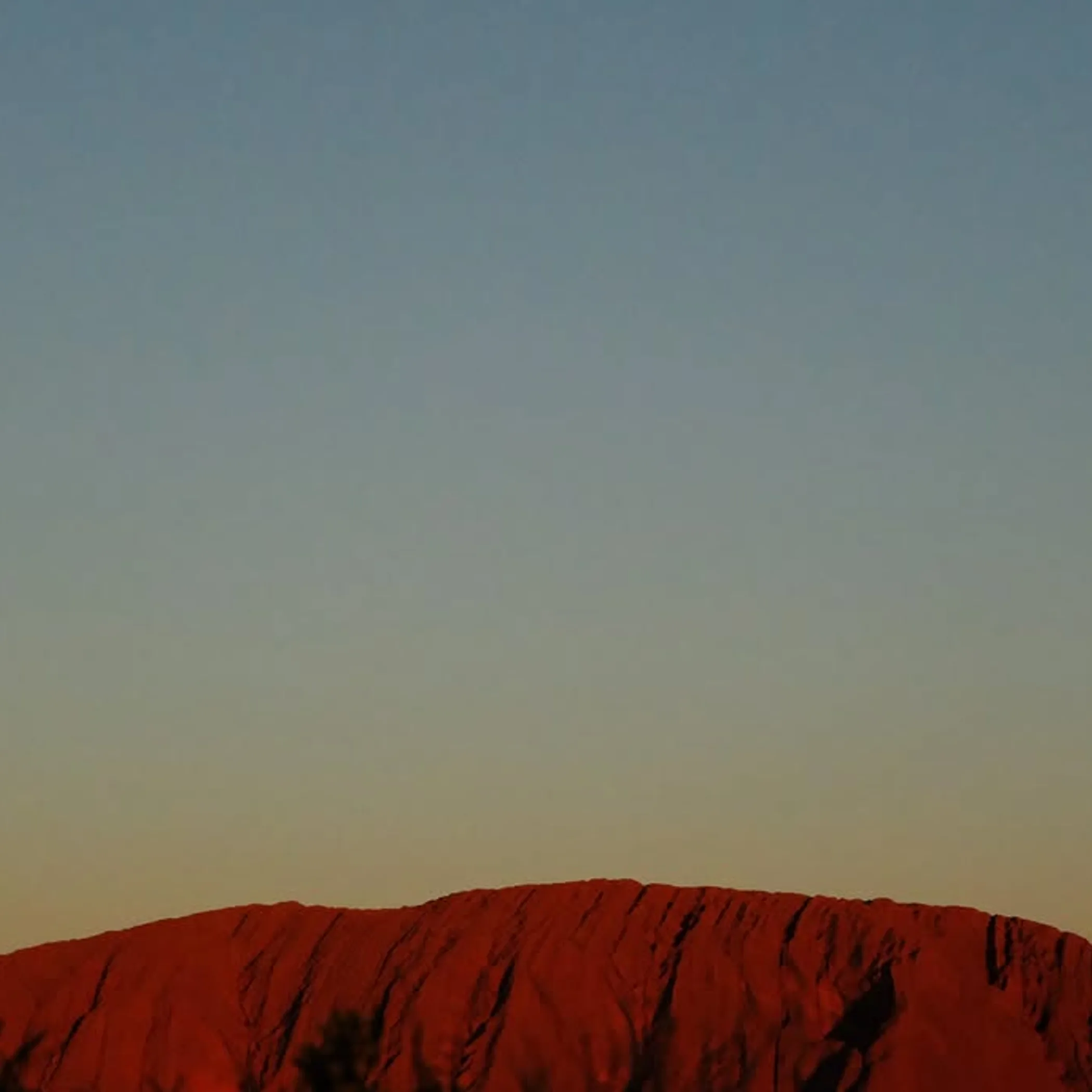 uluru rock formation under clear sky