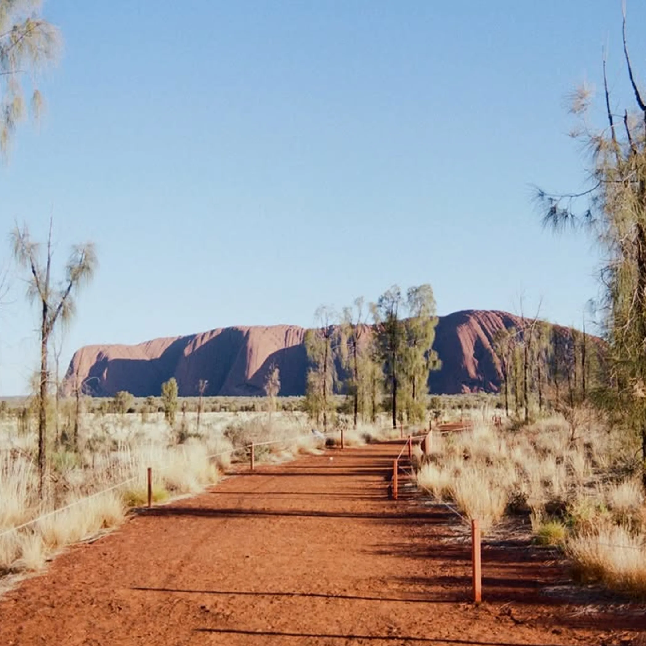 uluru rock formation under clear sky