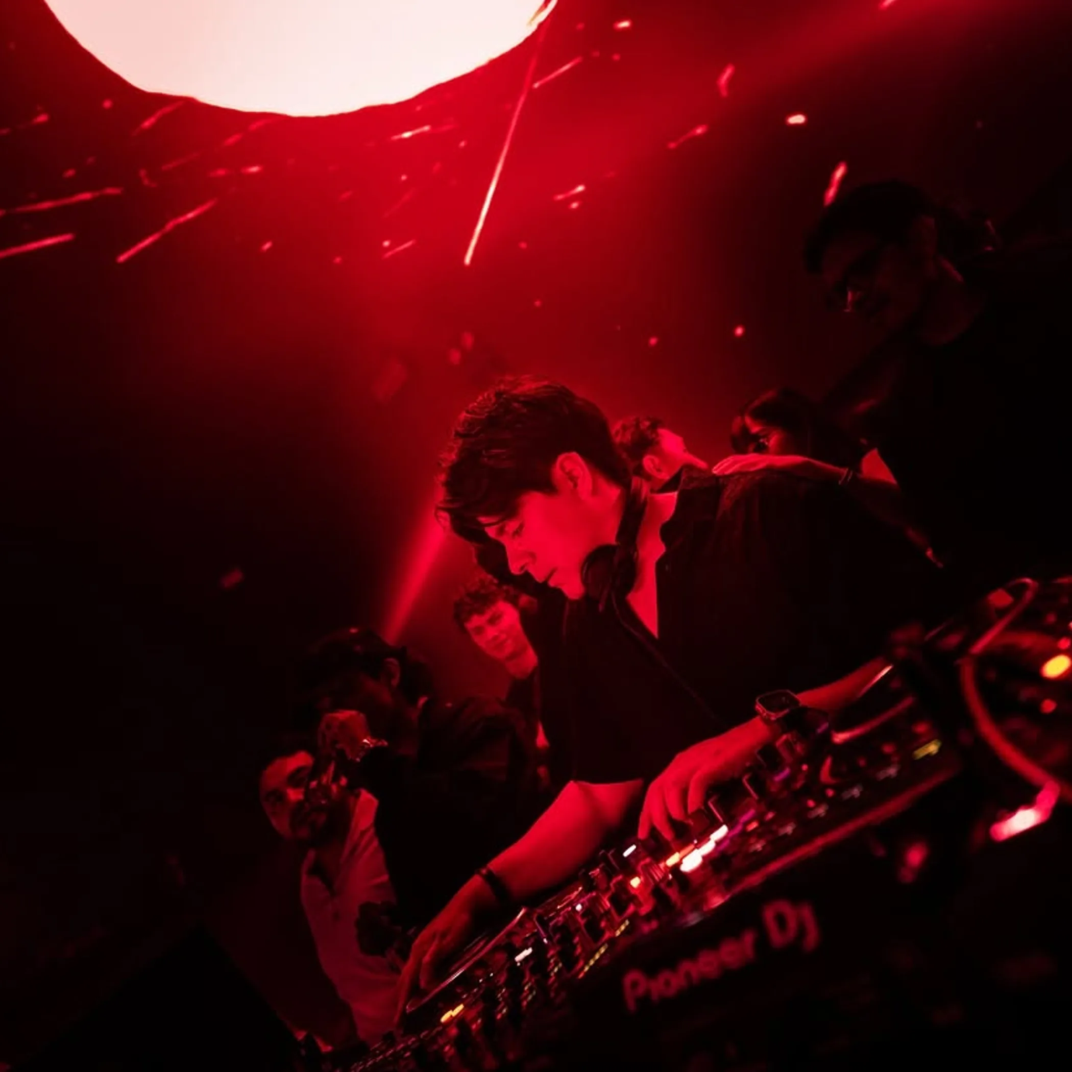 dj performing in nightclub crowd