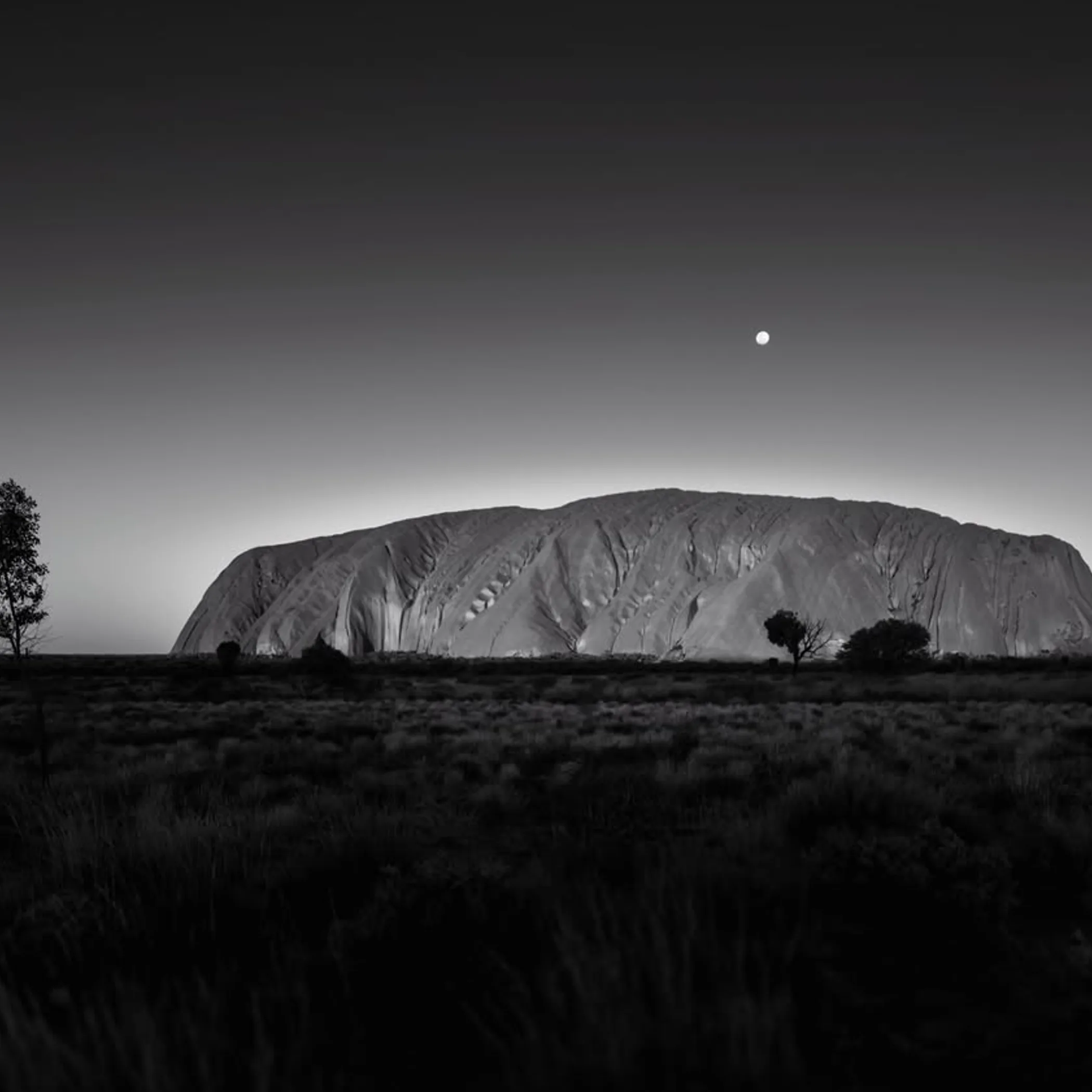 uluru rock formation under clear sky